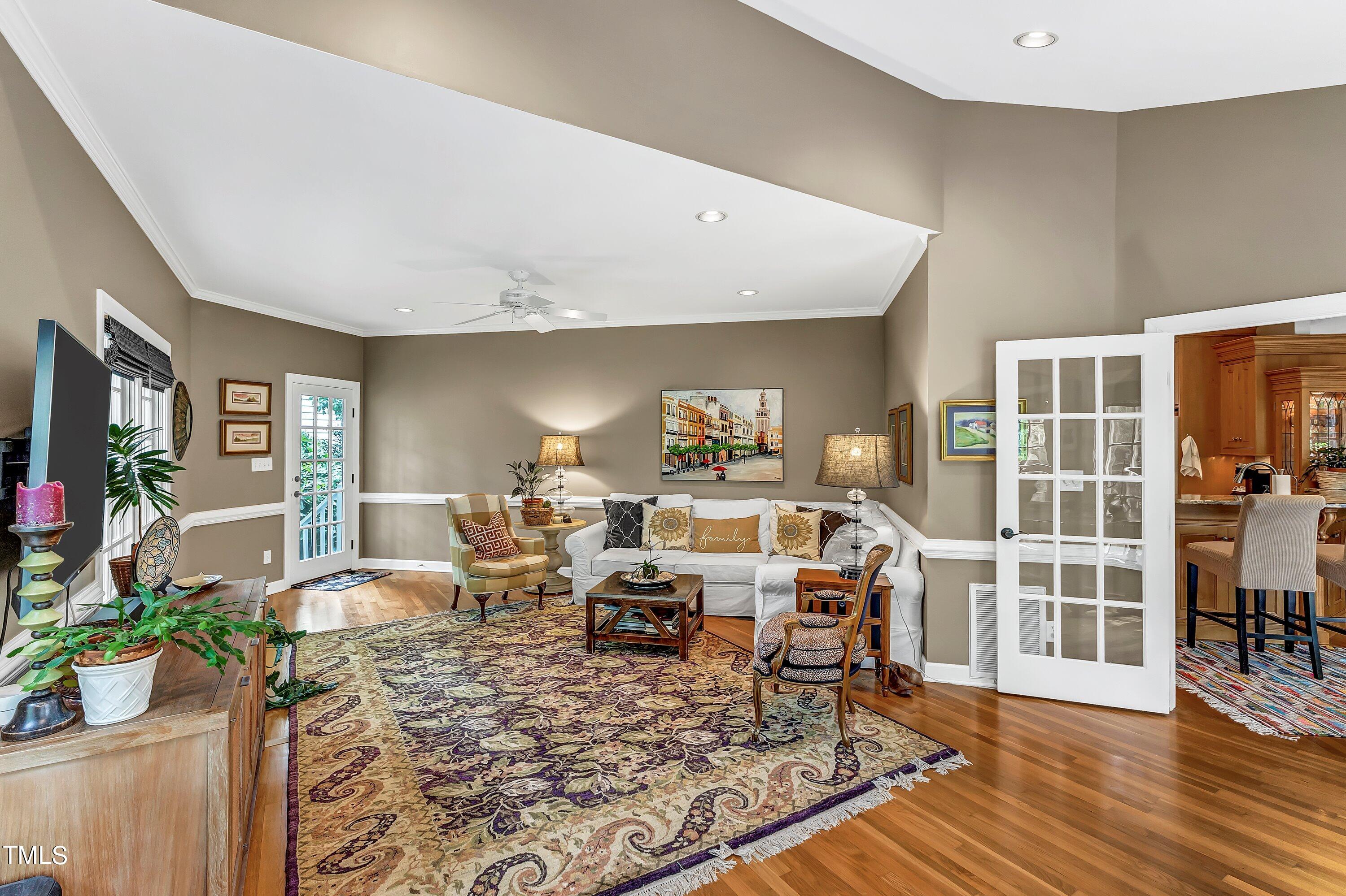 6105 Montcastle Court Raleigh, NC 27612 - Photo 21 of 44 a living room with furniture hard wood floor and a rug