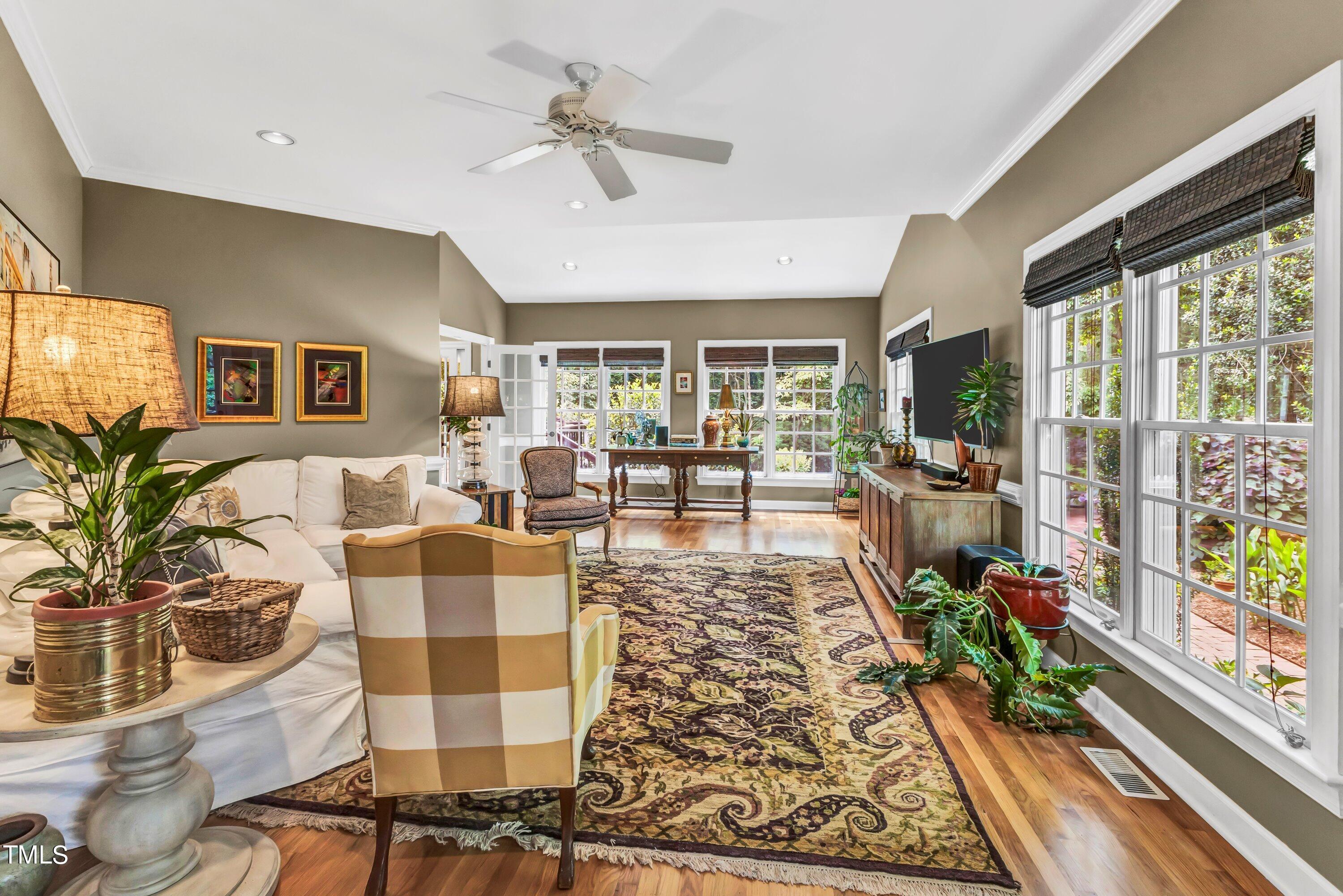 6105 Montcastle Court Raleigh, NC 27612 - Photo 22 of 44 a living room with patio furniture and a floor to ceiling window