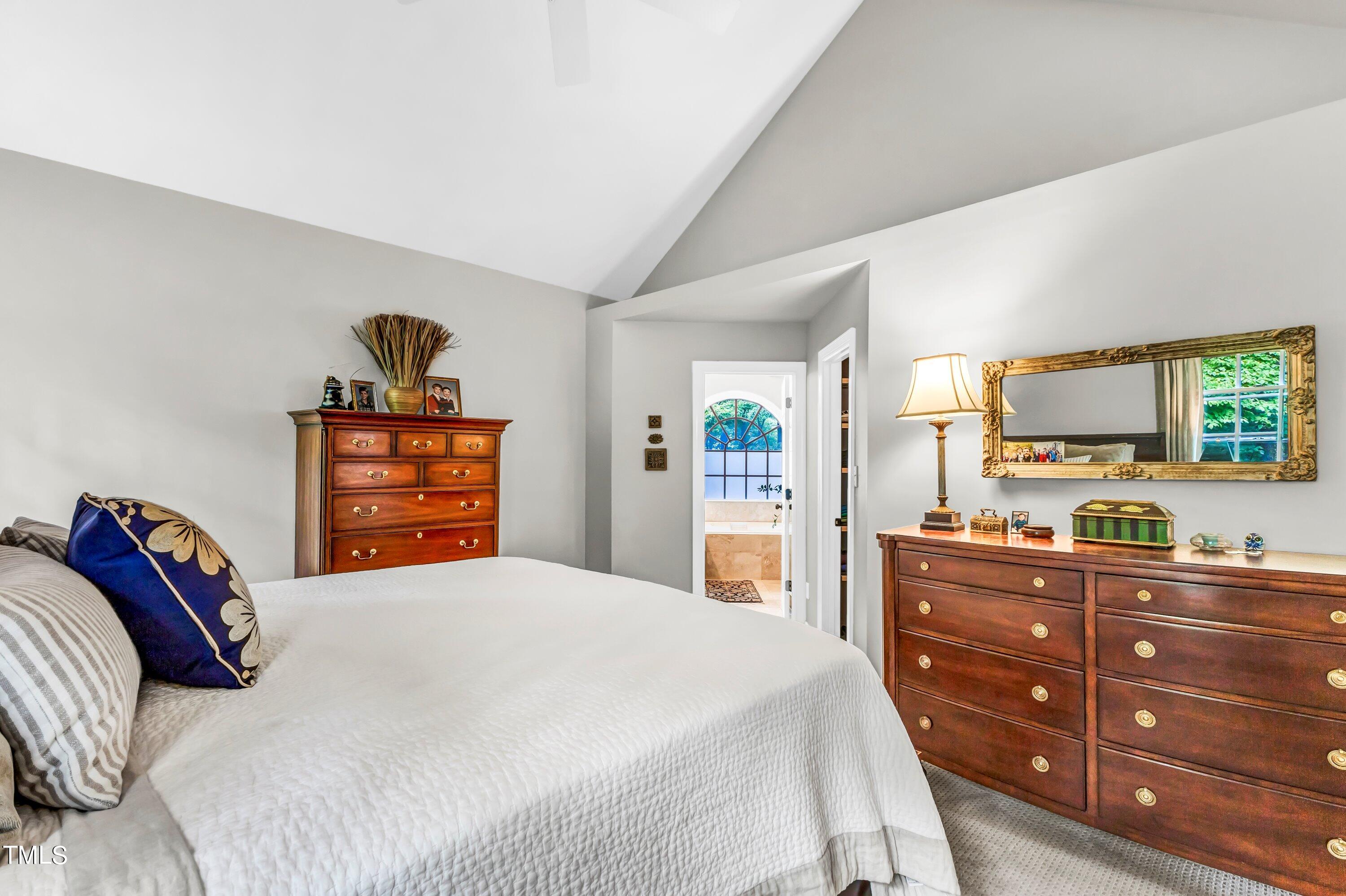 6105 Montcastle Court Raleigh, NC 27612 - Photo 25 of 44 a bedroom with a bed and a dresser in it