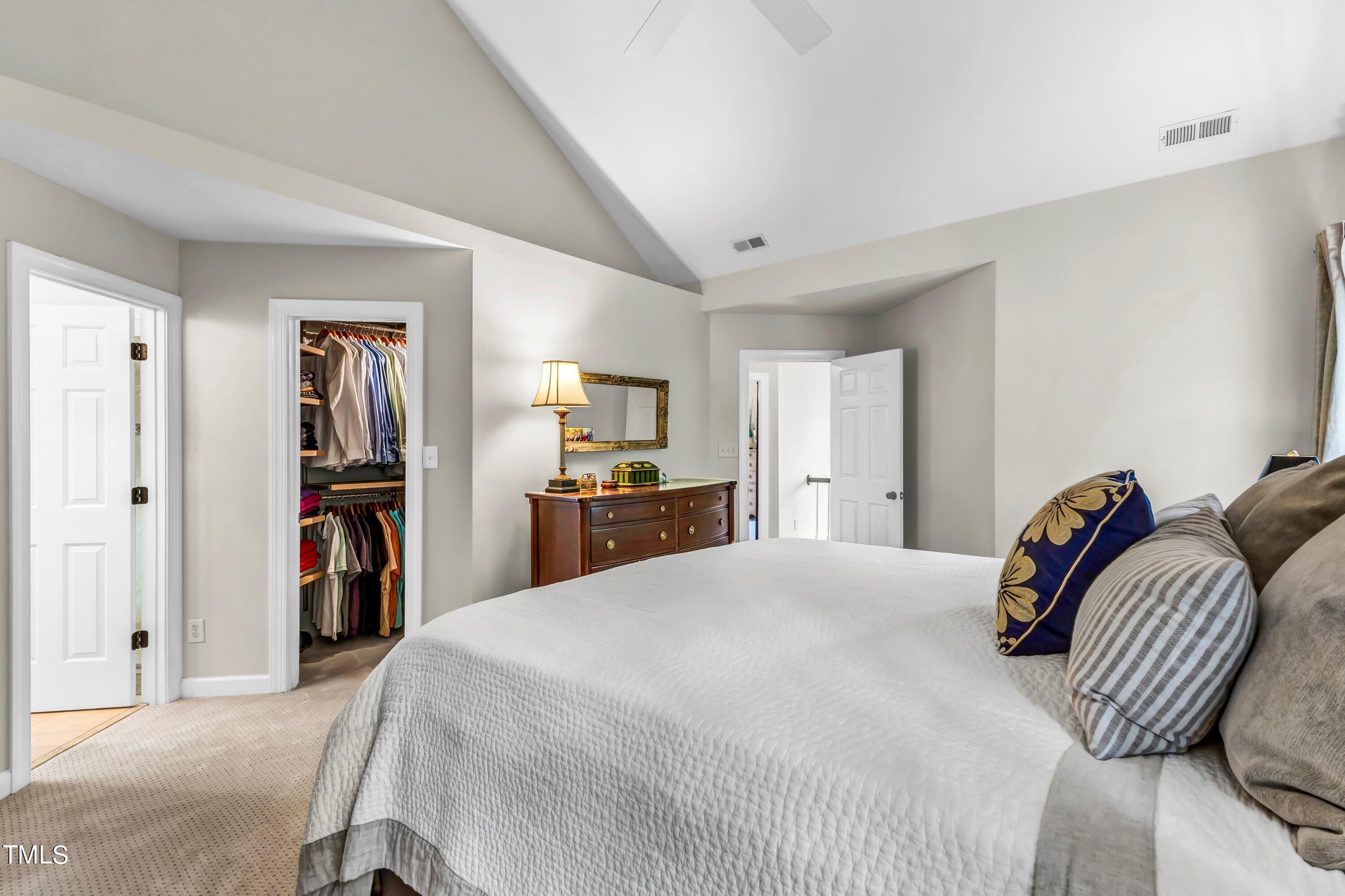 6105 Montcastle Court Raleigh, NC 27612 - Photo 26 of 44 a bedroom with a bed and a closet