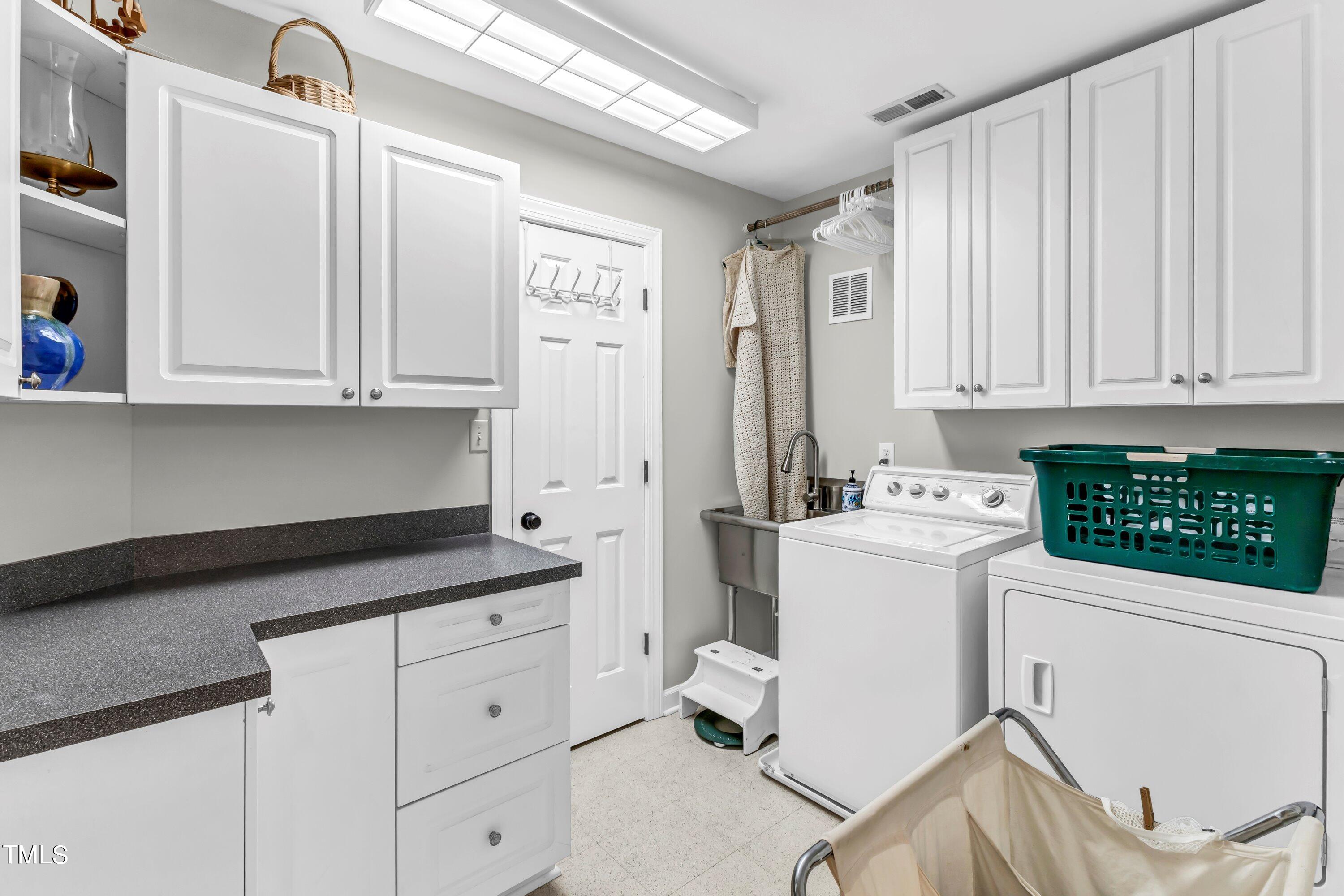 6105 Montcastle Court Raleigh, NC 27612 - Photo 31 of 44 a view of a kitchen with fridge and workspace