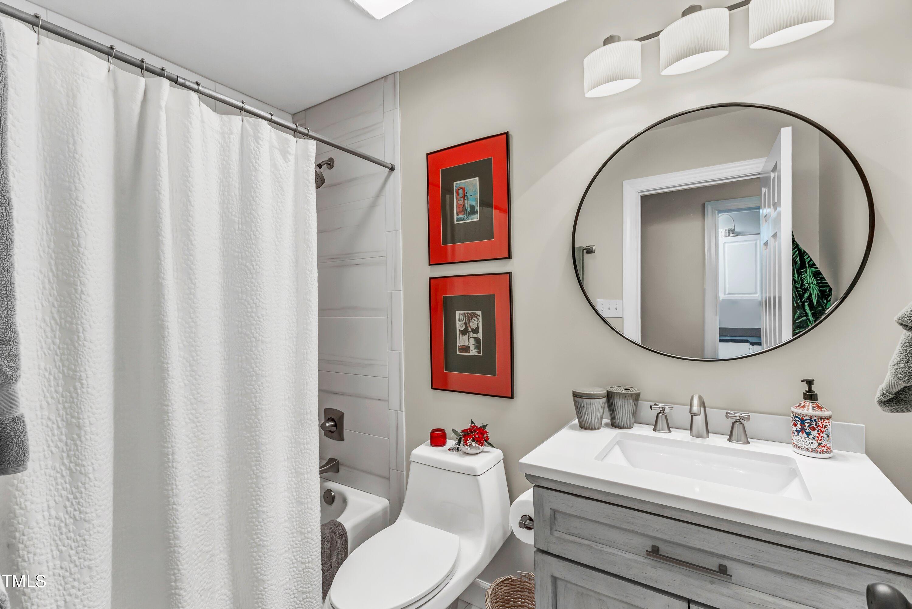 6105 Montcastle Court Raleigh, NC 27612 - Photo 33 of 44 a bathroom with a sink vanity mirror and toilet
