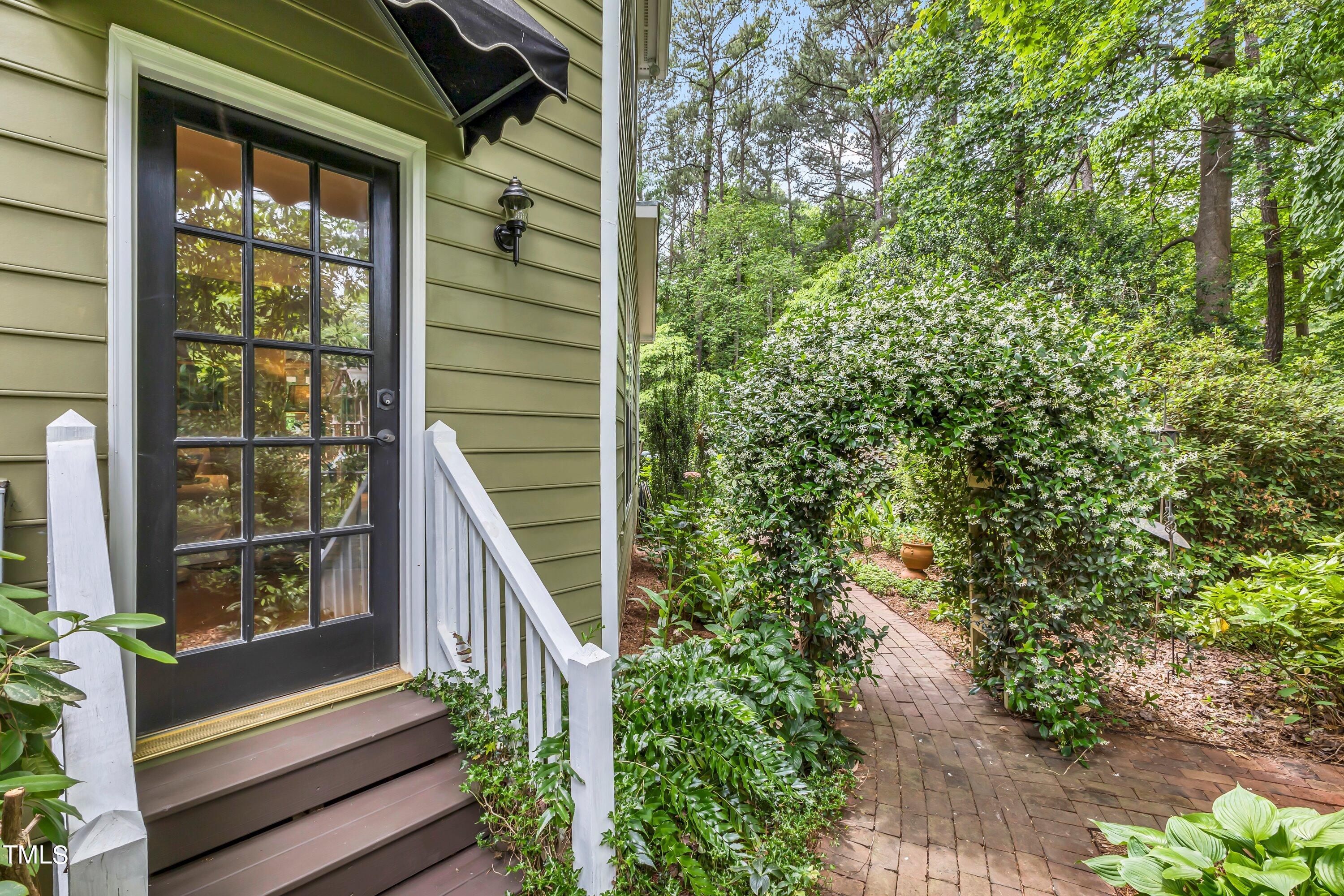 6105 Montcastle Court Raleigh, NC 27612 - Photo 37 of 44 a view of wooden house with a yard