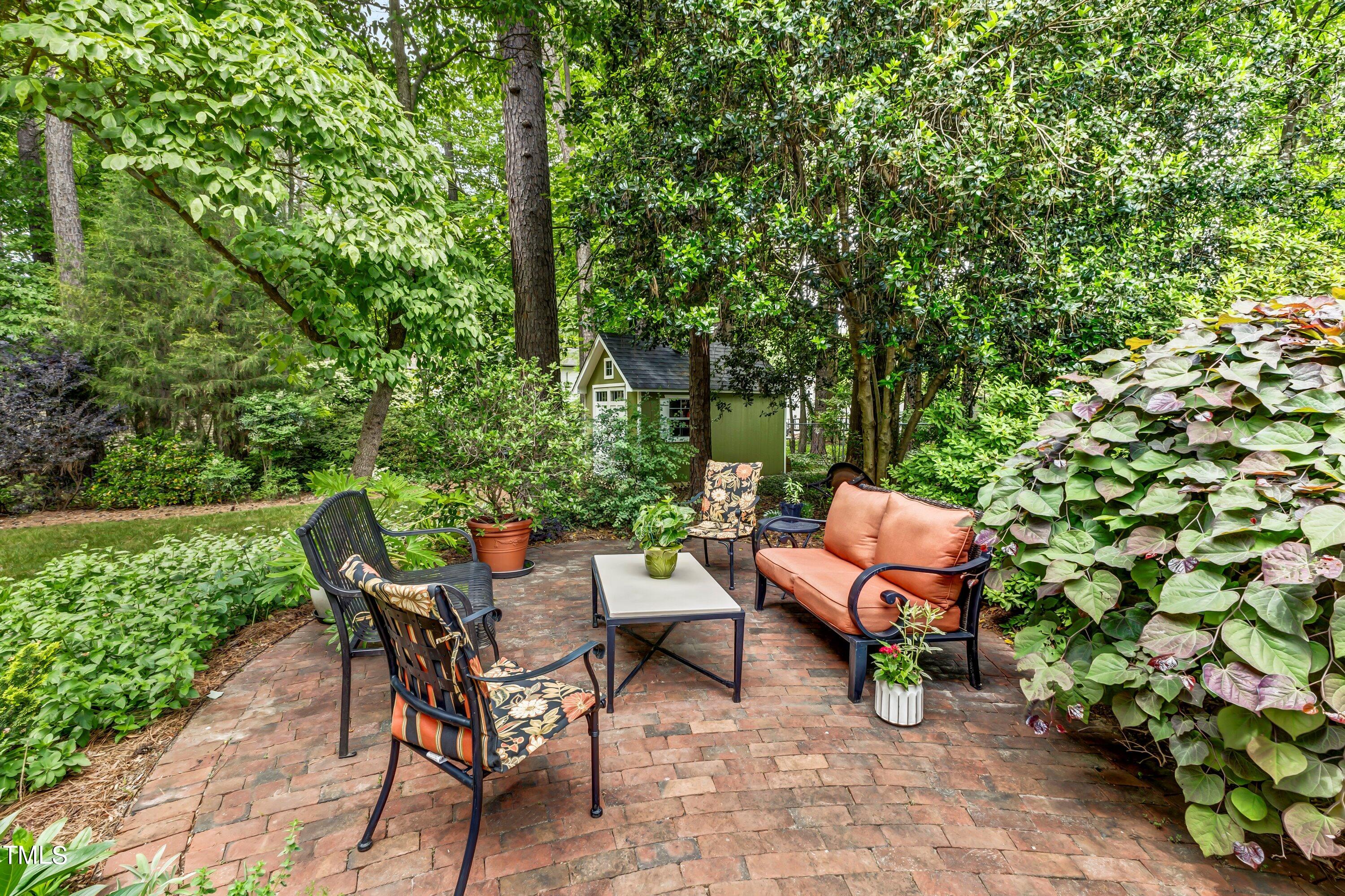6105 Montcastle Court Raleigh, NC 27612 - Photo 39 of 44 a backyard of a house with table and chairs
