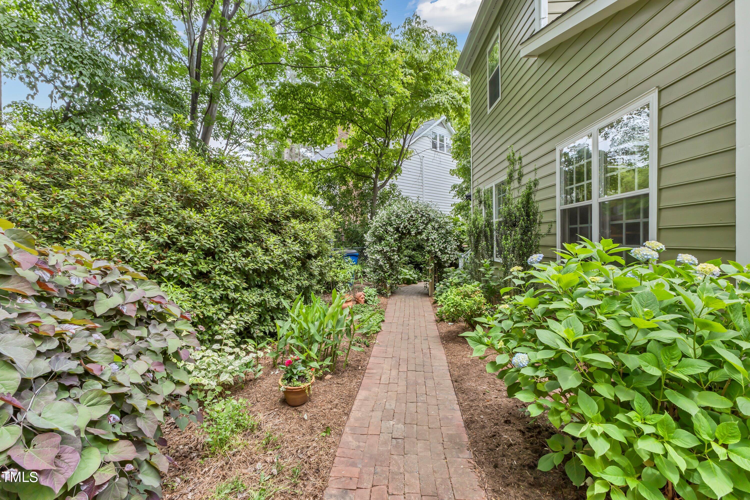 6105 Montcastle Court Raleigh, NC 27612 - Photo 40 of 44 a view of a pathway with plants and large trees