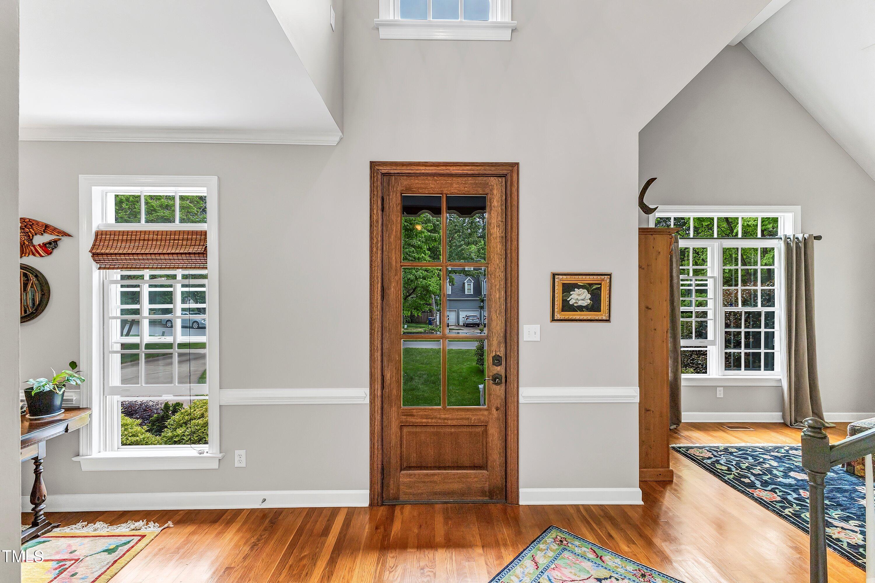 6105 Montcastle Court Raleigh, NC 27612 - Photo 4 of 44 a view of a bedroom with wooden floor and windows