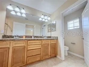 a bathroom with a granite countertop sink mirror and double