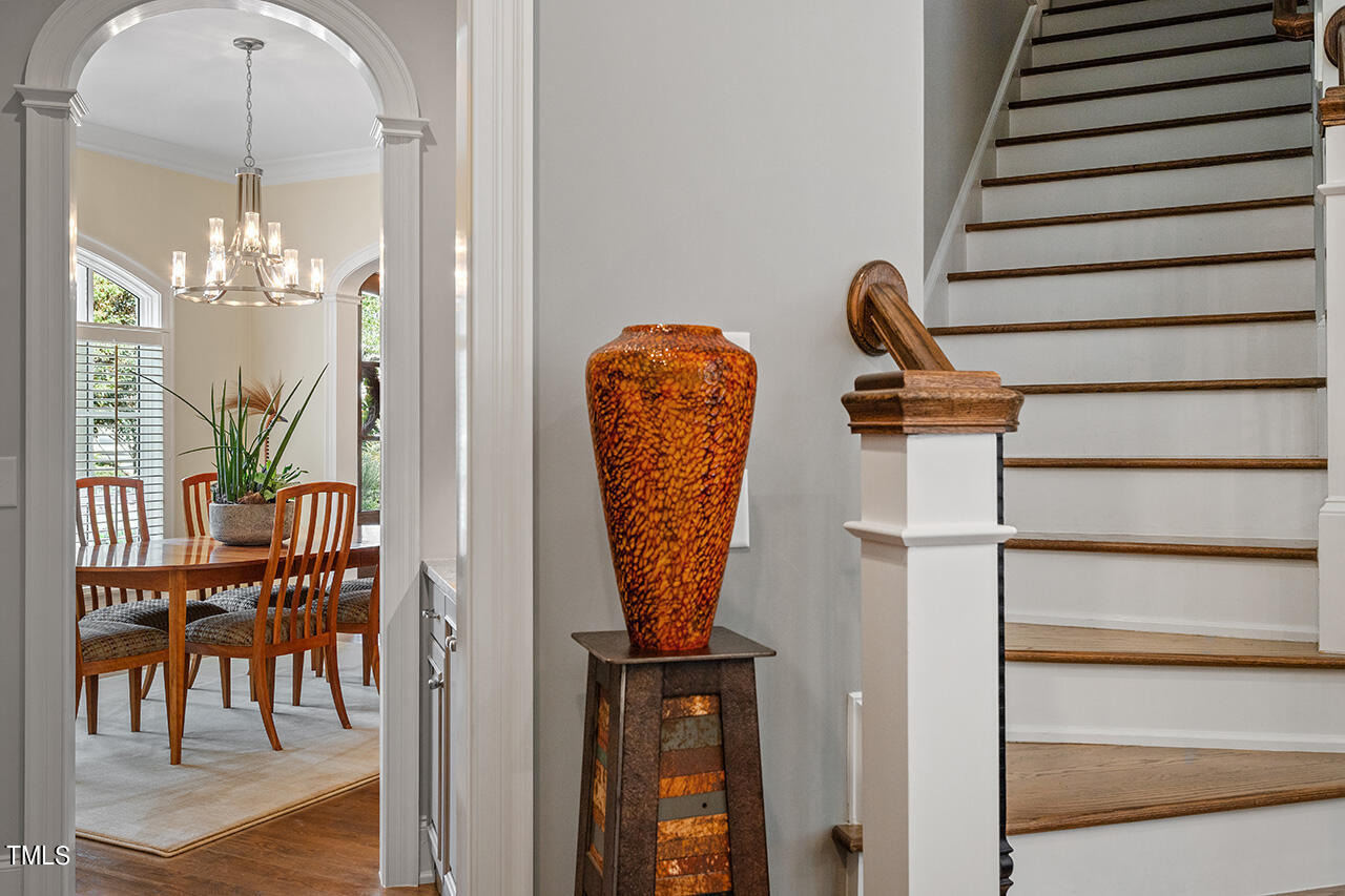 6940 Bartons Bend Way Raleigh, NC 27614 - Photo 11 of 66 a view of a hallway with dining area and chandelier