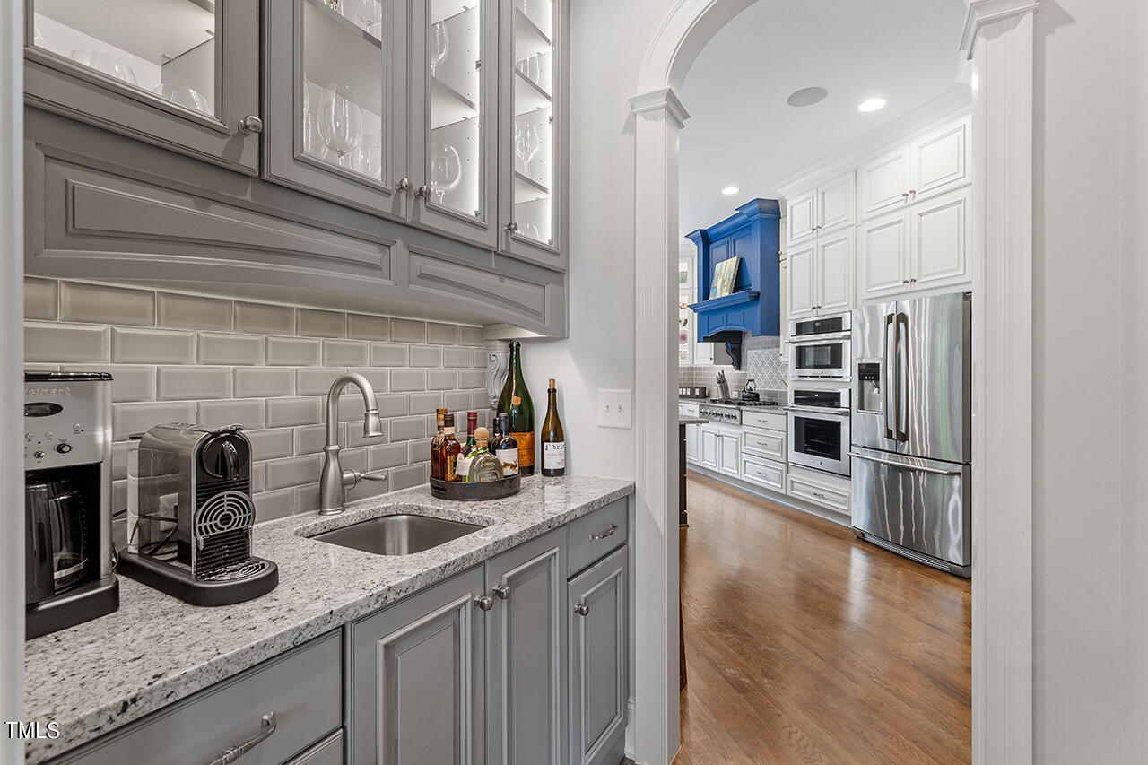 6940 Bartons Bend Way Raleigh, NC 27614 - Photo 24 of 66 a kitchen with stainless steel appliances granite countertop a sink refrigerator and cabinets