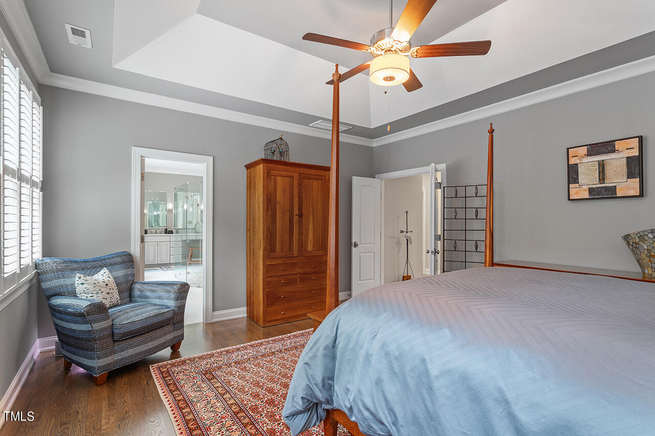 6940 Bartons Bend Way Raleigh, NC 27614 - Photo 30 of 66 a bedroom with a bed couch and a walk in closet