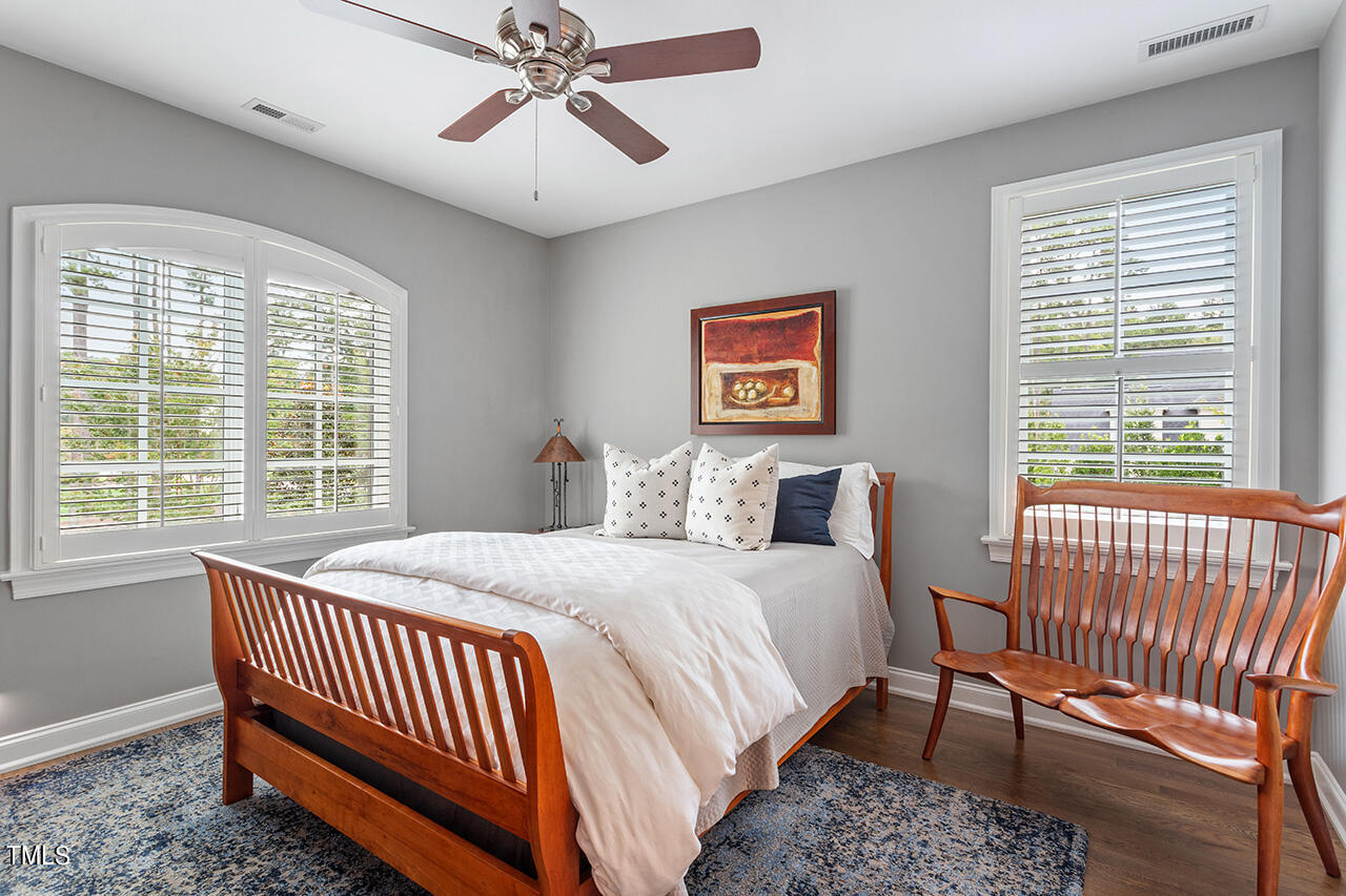 6940 Bartons Bend Way Raleigh, NC 27614 - Photo 34 of 66 a bed sitting in a bedroom next to a window