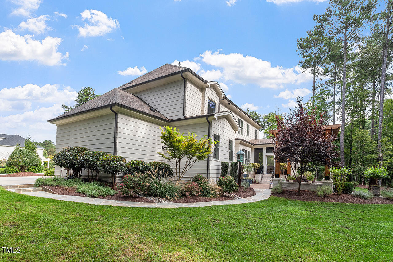 6940 Bartons Bend Way Raleigh, NC 27614 - Photo 54 of 66 a front view of a house with a yard table and chairs