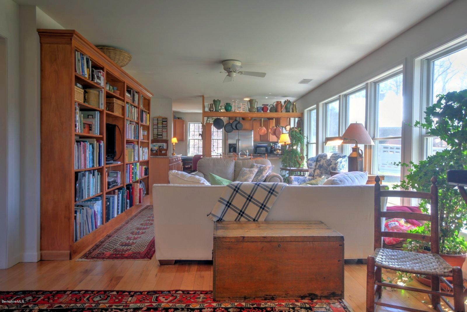 20 Main Road Tyringham, MA 01238 - Photo 16 of 50 a living room with furniture and a book shelf