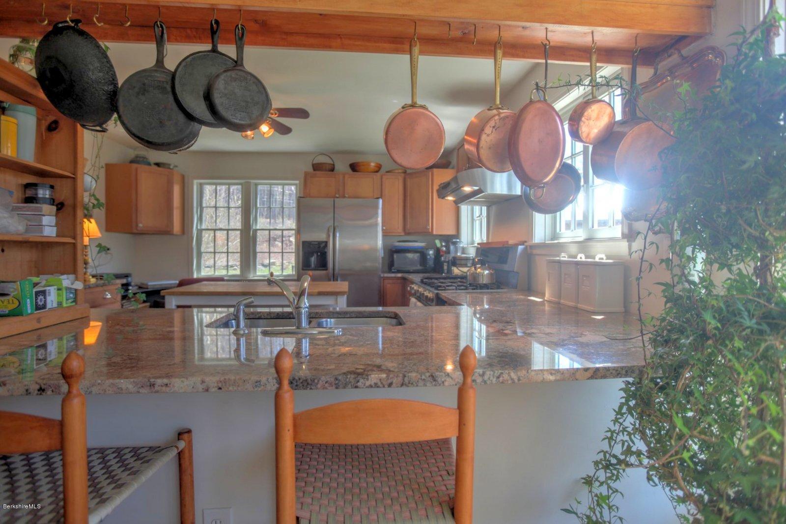 20 Main Road Tyringham, MA 01238 - Photo 21 of 50 a kitchen with a stove a kitchen island a stove and a chair