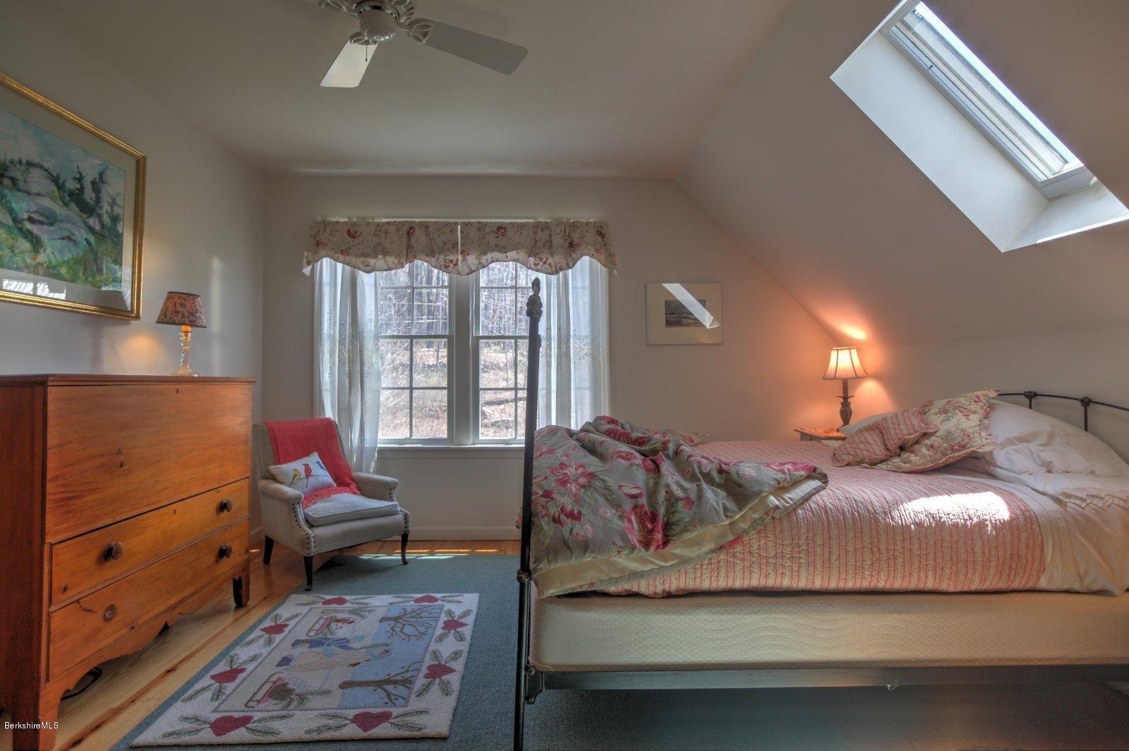 20 Main Road Tyringham, MA 01238 - Photo 33 of 50 a bedroom with a bed and wooden floor