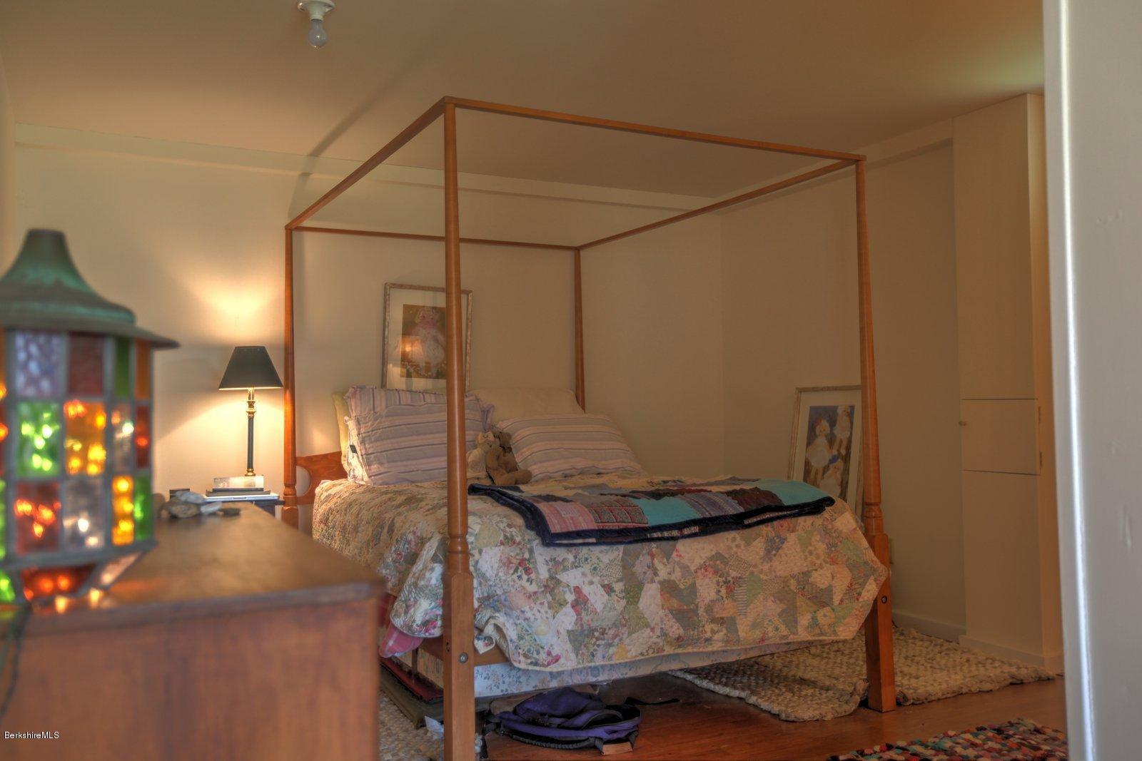 20 Main Road Tyringham, MA 01238 - Photo 41 of 50 a living room with a couch and chandelier