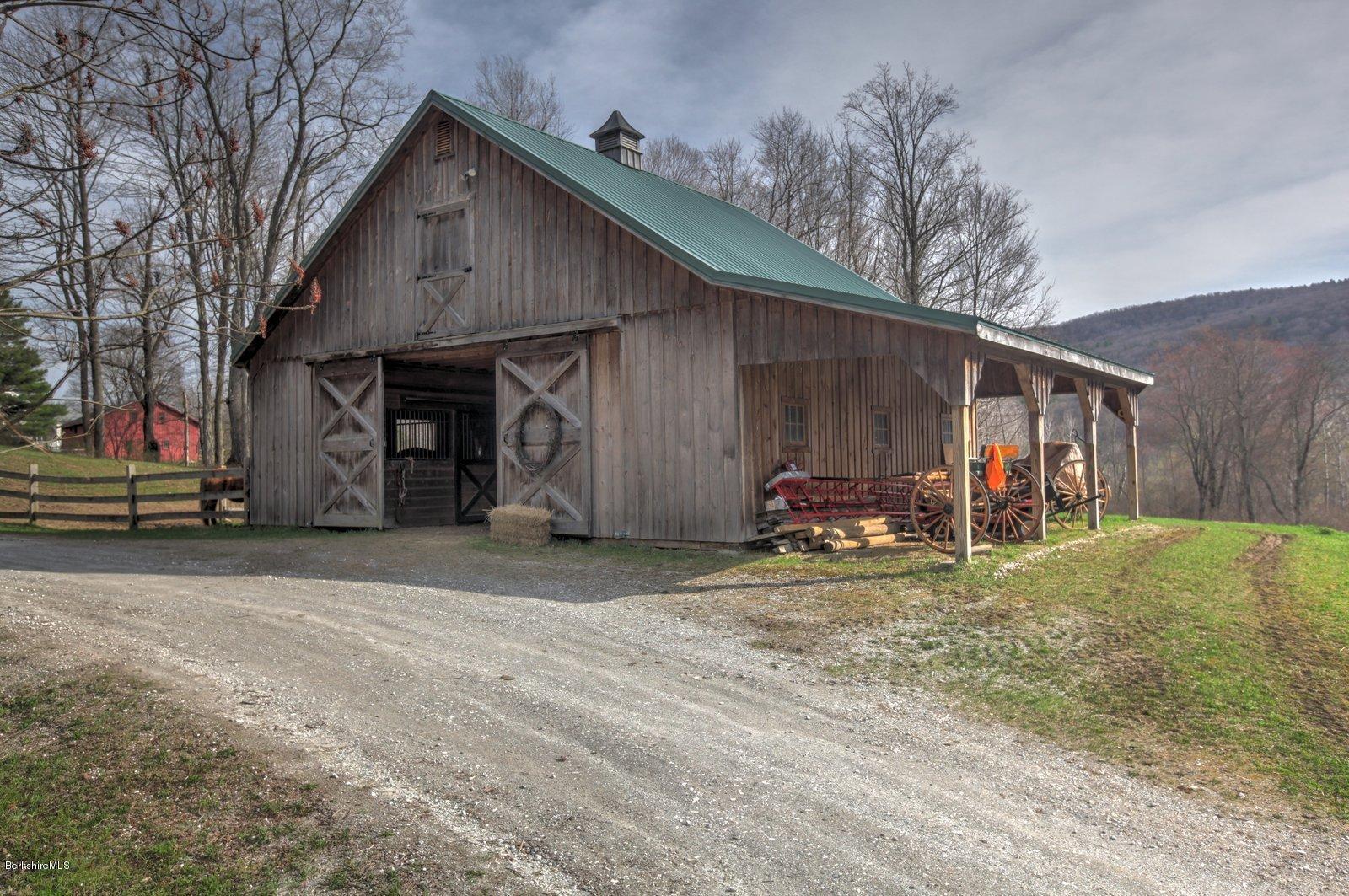 20 Main Road Tyringham, MA 01238 - Photo 9 of 50 a view of a house with a yard and garage