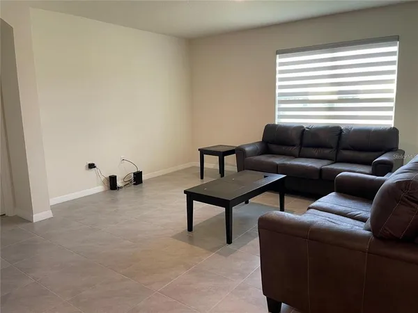 a living room with furniture and a window