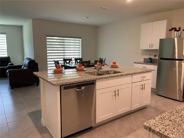 a kitchen with a sink stove and refrigerator