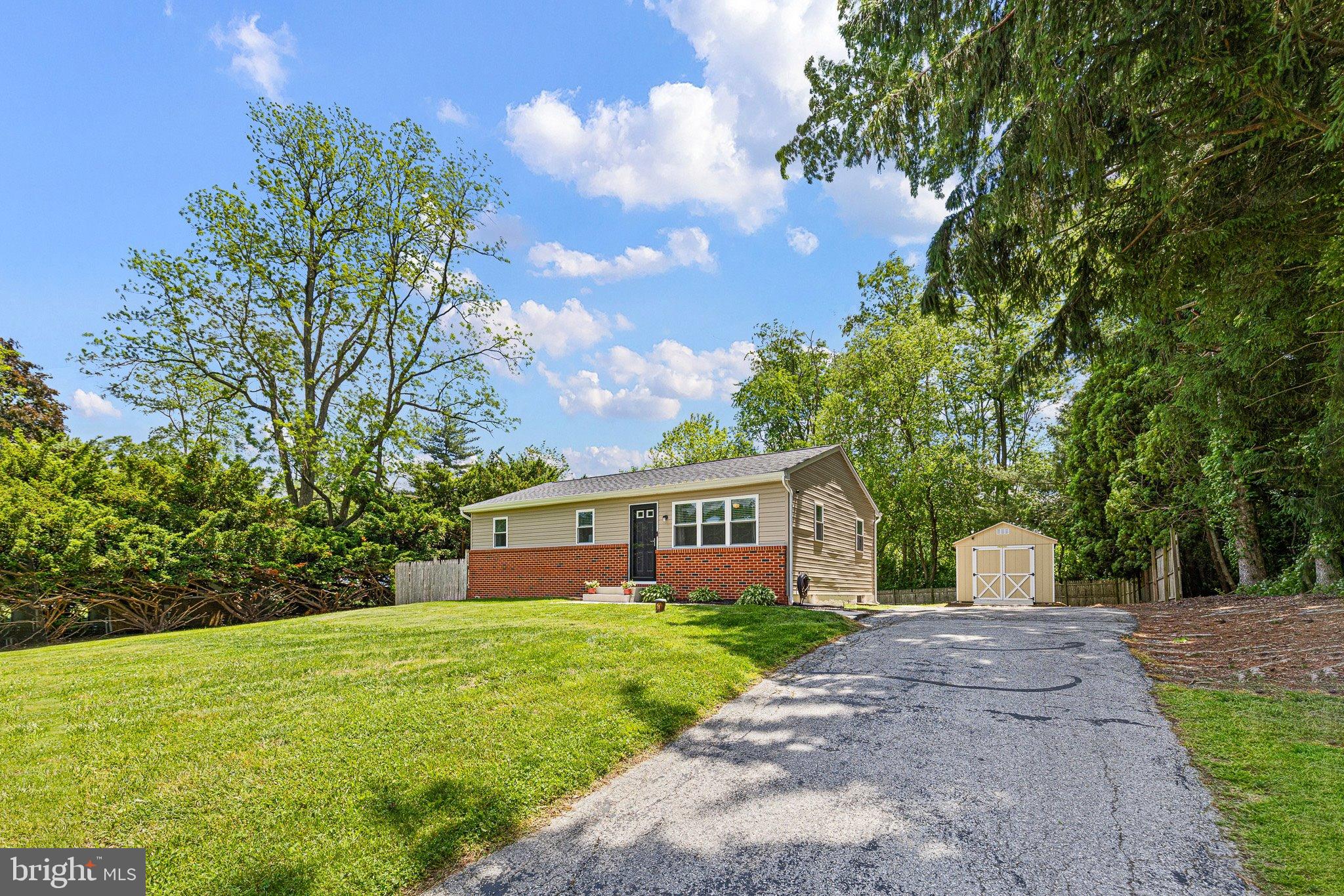 370 Big Elk Chapel Road Elkton, MD 21921 - Photo 3 of 29 a front view of a house with a yard and trees