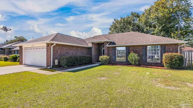 a front view of a house with yard and garage