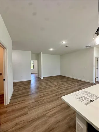 a view of an empty room and wooden floor