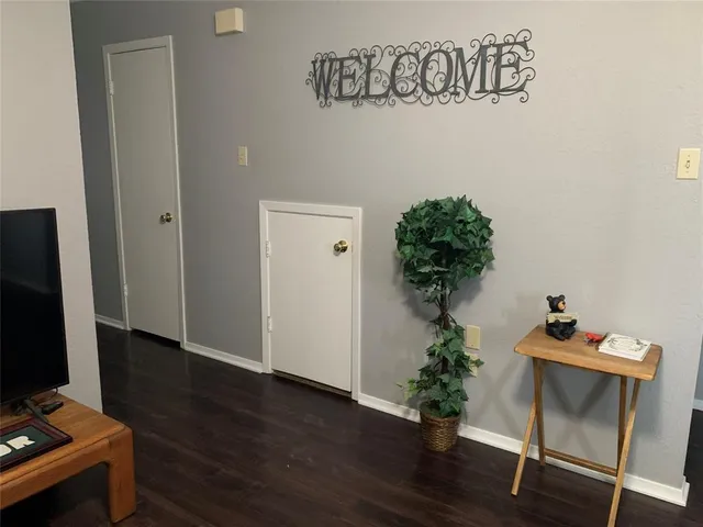 a view of a workspace with furniture and wooden floor