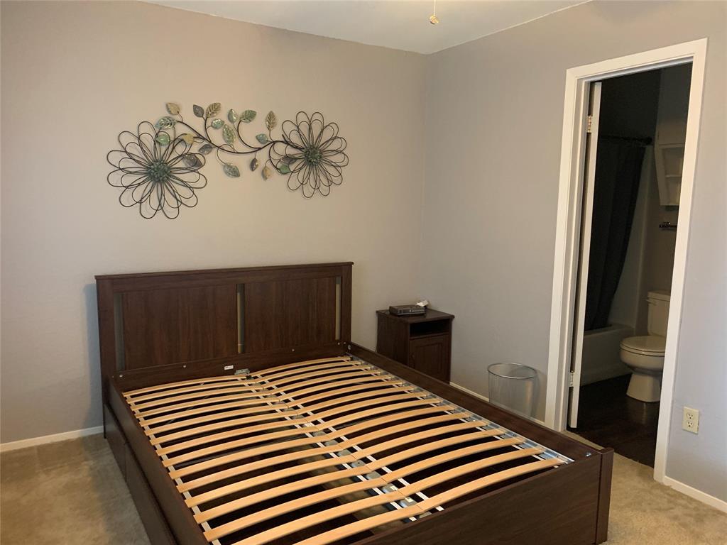 1226 Baylor Avenue, Unit 101 Waco, TX 76706 - Photo 7 of 8 a bedroom with a bed and a wall painting