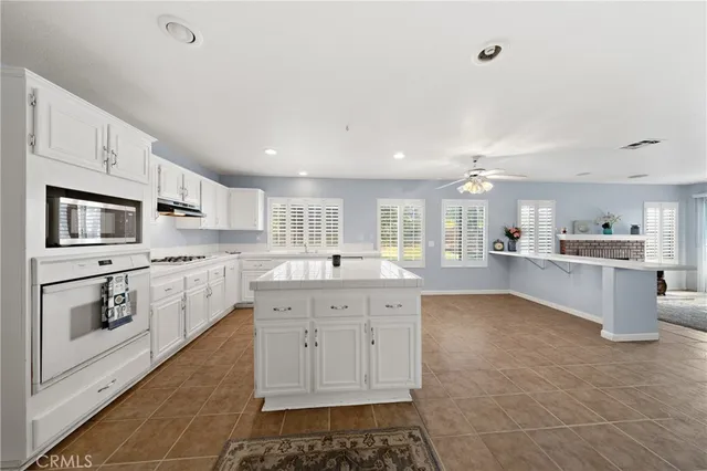 a large white kitchen with cabinets