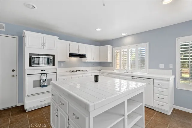a kitchen with granite countertop a sink and a stove