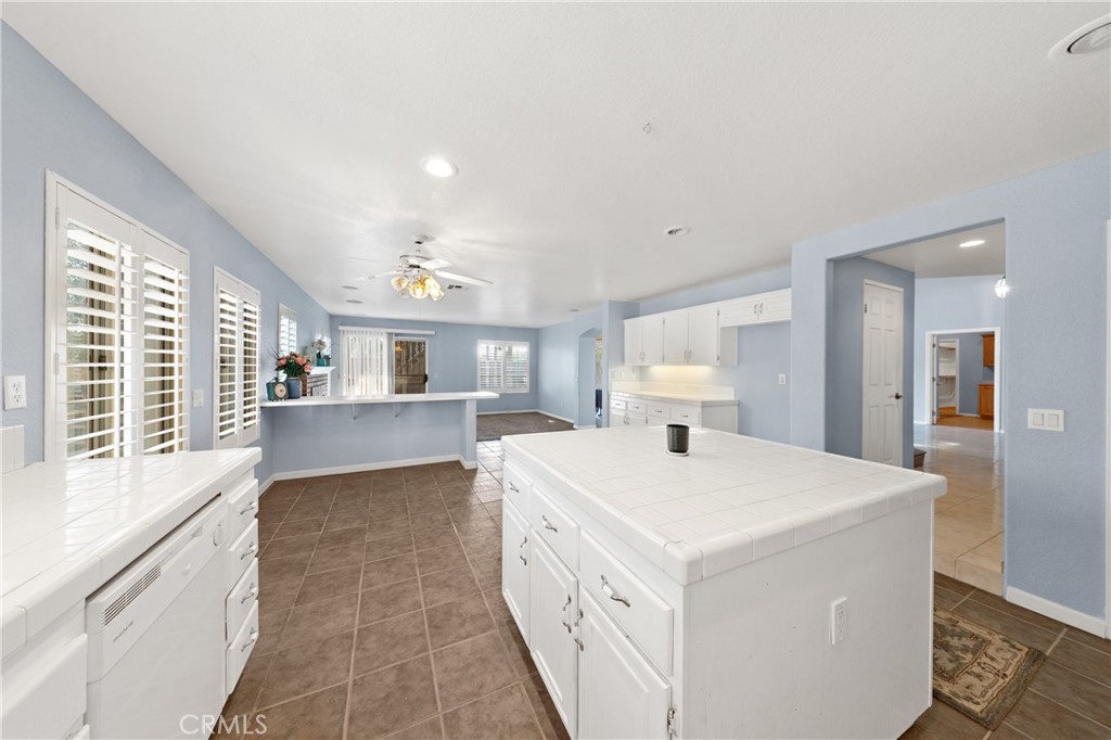 32858 Alderbrook Road Wildomar, CA 92595 - Photo 16 of 56 a large white kitchen with sink and white cabinets