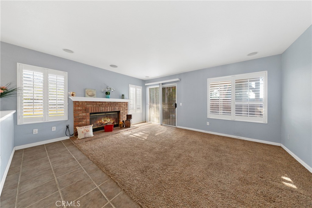 32858 Alderbrook Road Wildomar, CA 92595 - Photo 18 of 56 a view of an empty room with a fireplace and a window