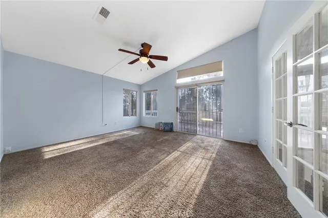 a view of a livingroom with a ceiling fan and window