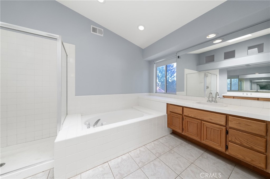 32858 Alderbrook Road Wildomar, CA 92595 - Photo 30 of 56 a spacious bathroom with a tub sink and mirror