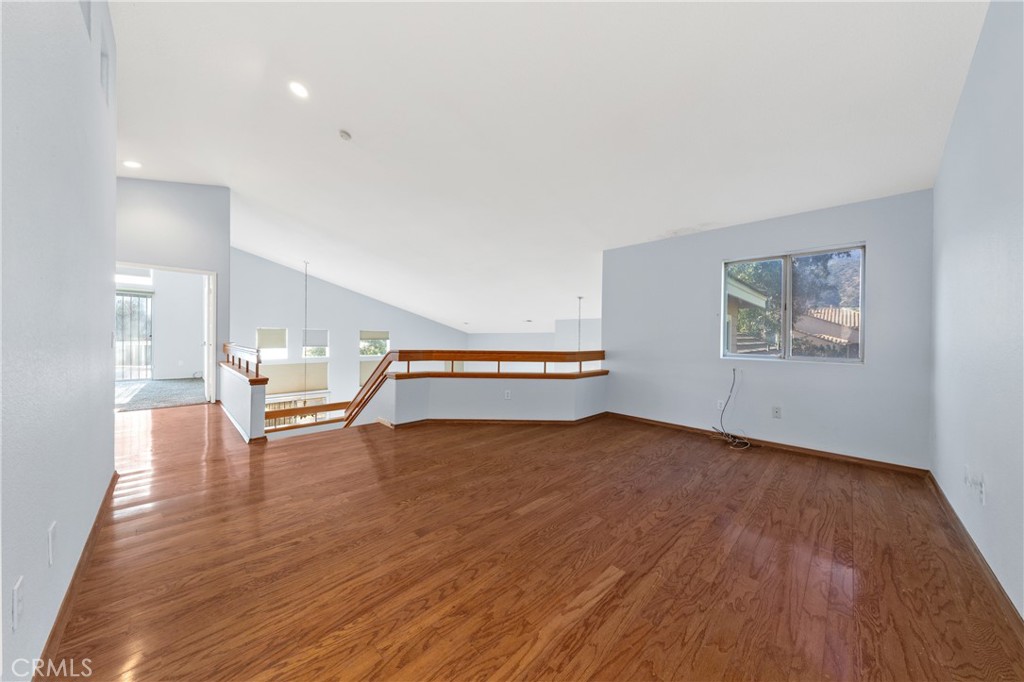32858 Alderbrook Road Wildomar, CA 92595 - Photo 33 of 56 a view of an empty room with wooden floor and a window