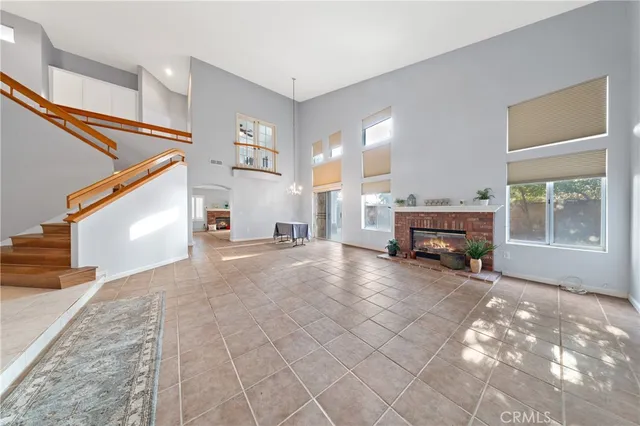 a view of a kitchen with white cabinets and a window