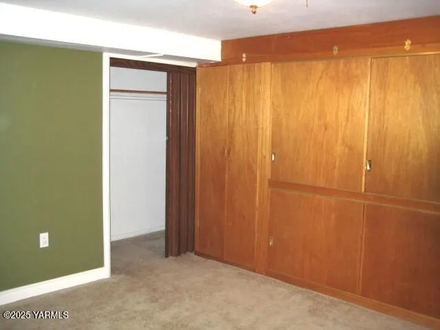 a living room with furniture and a book shelf
