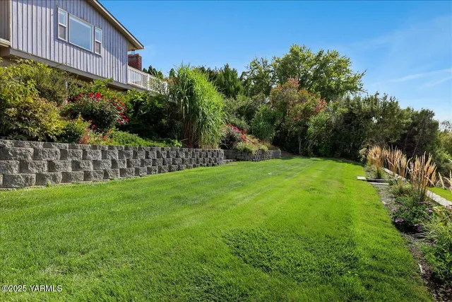 a view of a pathway with a wrought fence