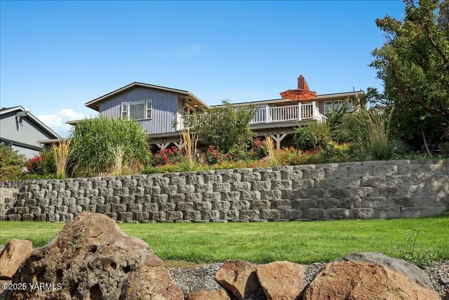 a view of a house with a big yard and plants