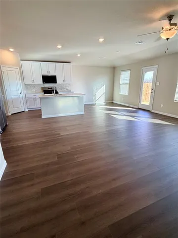a view of kitchen and hall with wooden floor