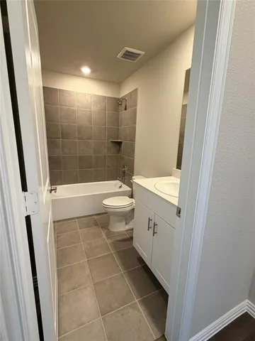 a bathroom with a bathtub and toilet