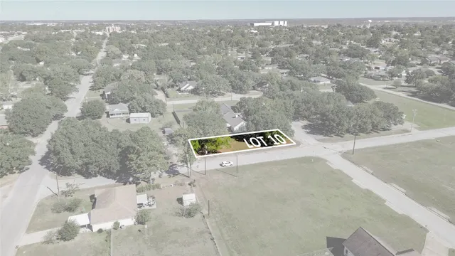 an aerial view of residential houses with outdoor space and swimming pool