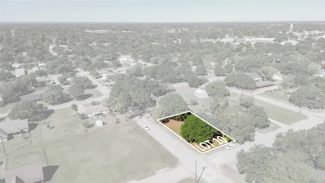 an aerial view of a forest with houses