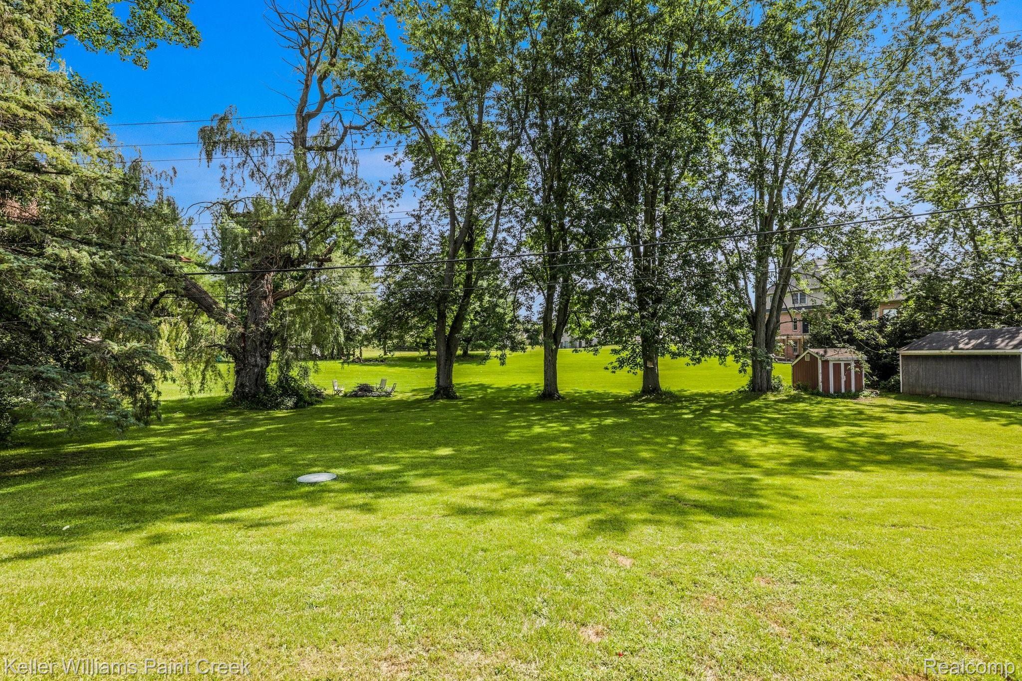 1146 East Gunn Road Rochester, MI 48306 - Photo 19 of 20 This lot is lined by sky-high trees and mature landscaping!