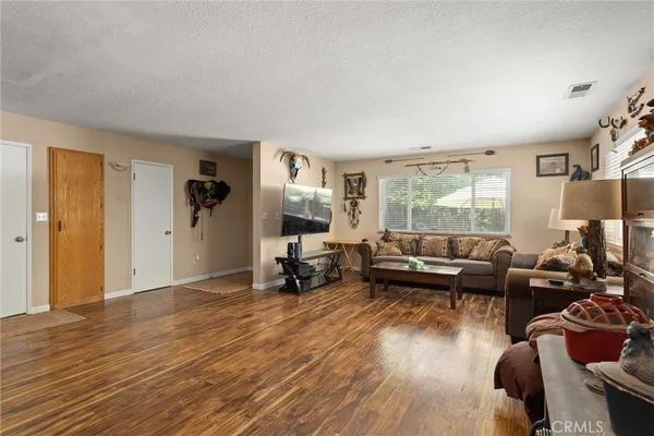 a kitchen with stainless steel appliances granite countertop a refrigerator a sink dishwasher a stove and a refrigerator