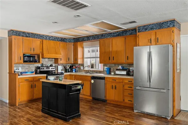 a kitchen with a window a sink and a refrigerator