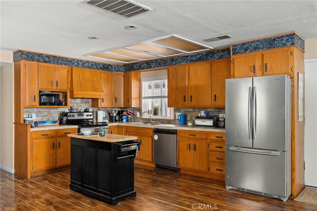 6176 Some Way Magalia, CA 95954 - Photo 13 of 46 a kitchen with stainless steel appliances granite countertop a refrigerator a sink dishwasher a stove and a refrigerator