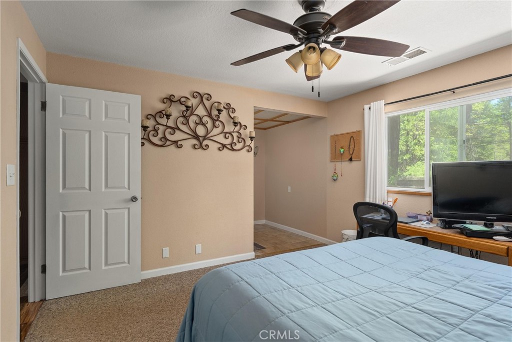 6176 Some Way Magalia, CA 95954 - Photo 21 of 46 a bedroom with a bed and a chandelier