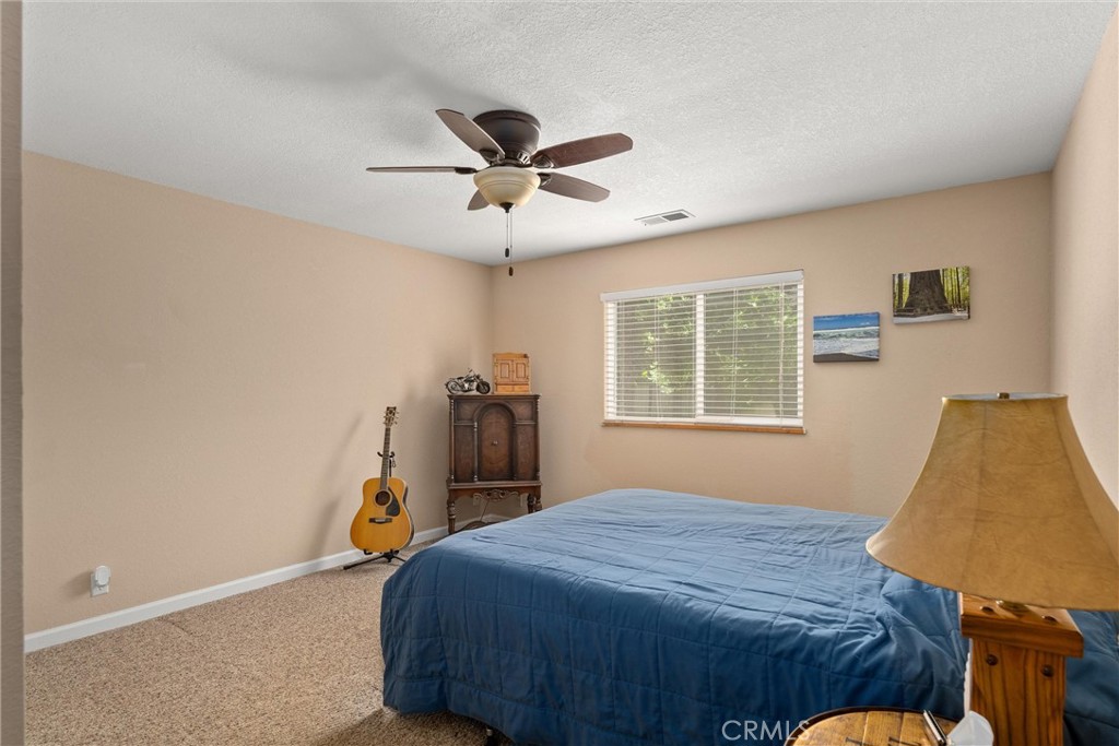 6176 Some Way Magalia, CA 95954 - Photo 24 of 46 a bedroom with a bed and a window