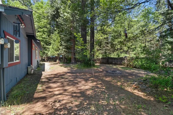 a backyard of a house with oven and tree